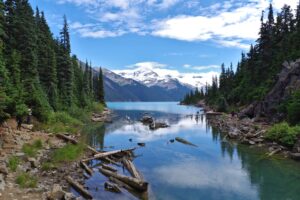 A symettrical view of Garibaldi Lake, with the mountains rising on either side.