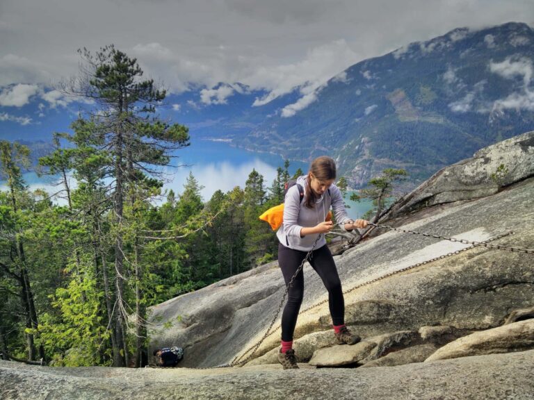 Woman using pre-installed chains to help her scramble up The Chief.