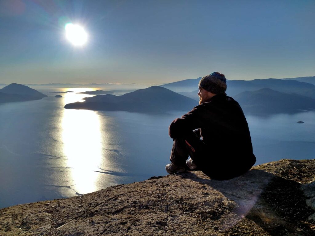 Seb sitting on the edge of Tunnel Bluffs cliff, contemplating life.