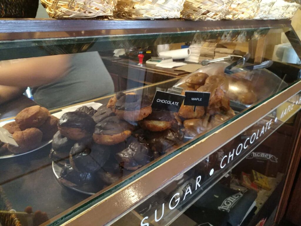 Donuts pictured with a chocolate or maple glaze.
