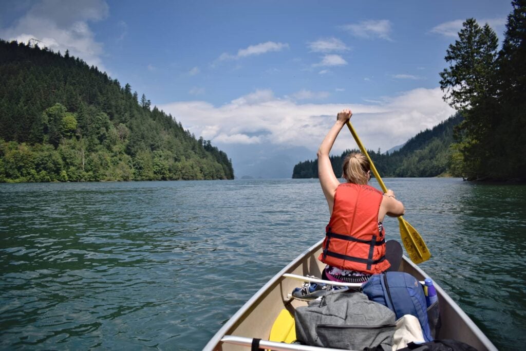 Blaize paddling in the front of a canoe on a glorious sunny day.