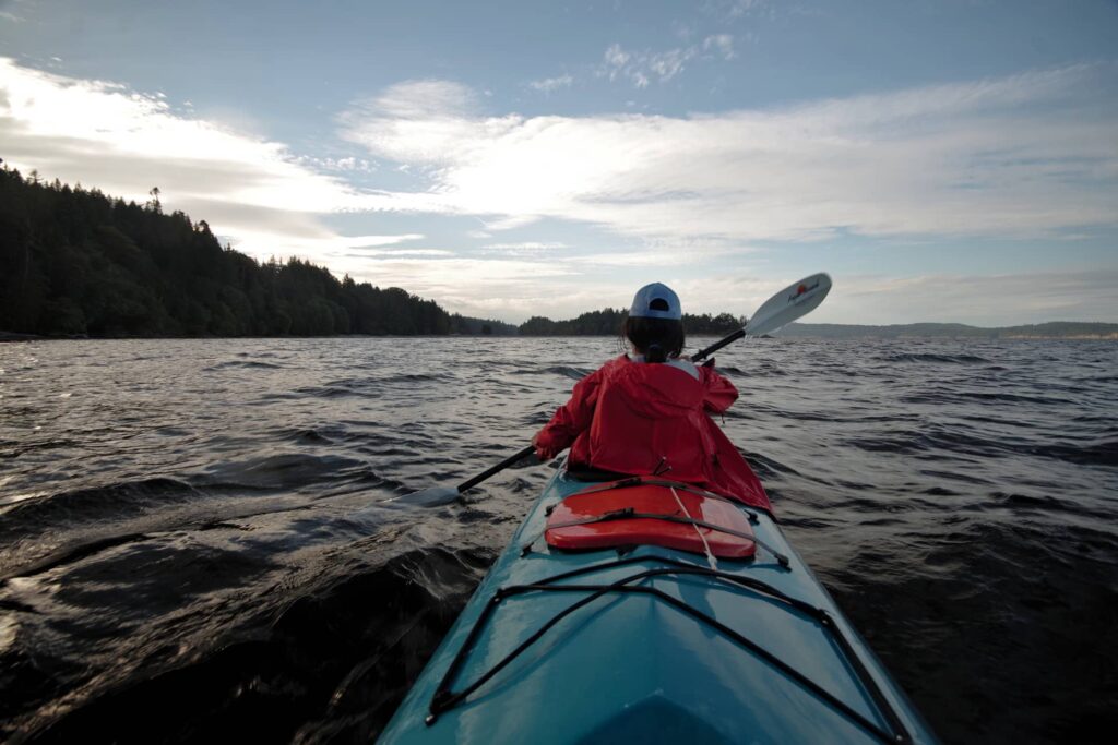 Ayelen wearing a rain jacket as we paddle towards Walter Hook beach.
